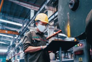 Factory working checking on the status of their dust collector